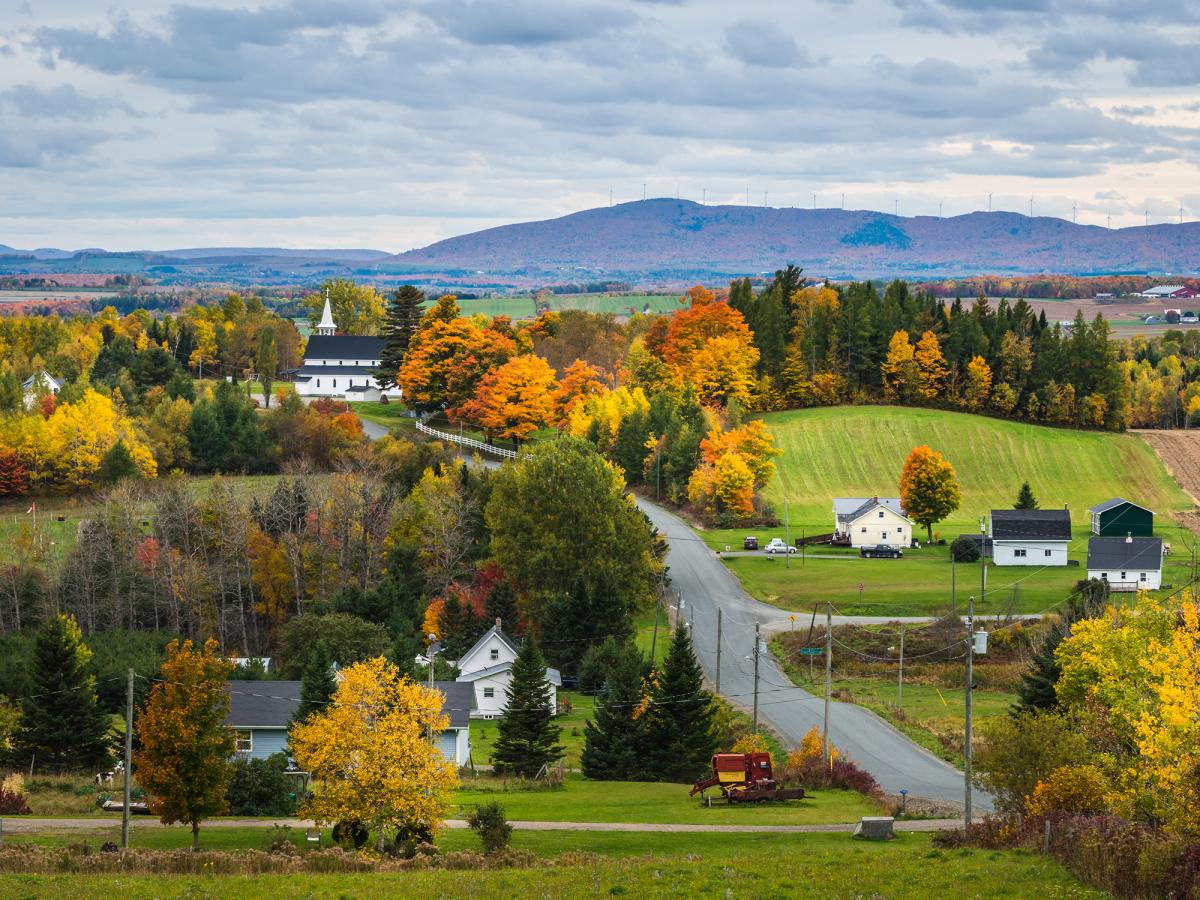 aerial shot of small eastern town with mountains in the background