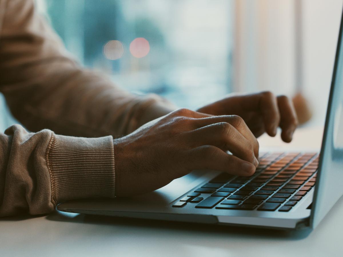 hands typing on keyboard