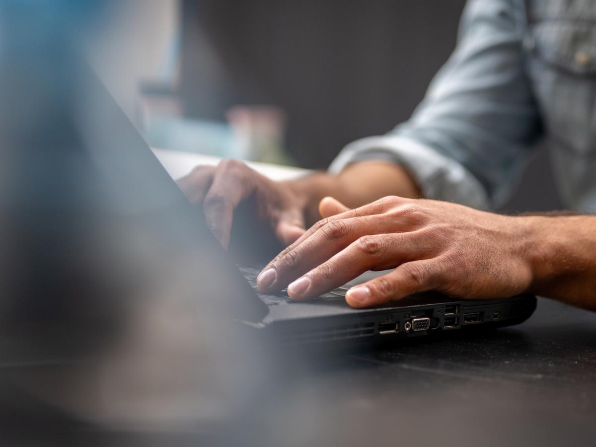 hands typing on a laptop